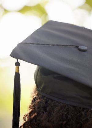 The back of the head of a woman wearing a graduation hat